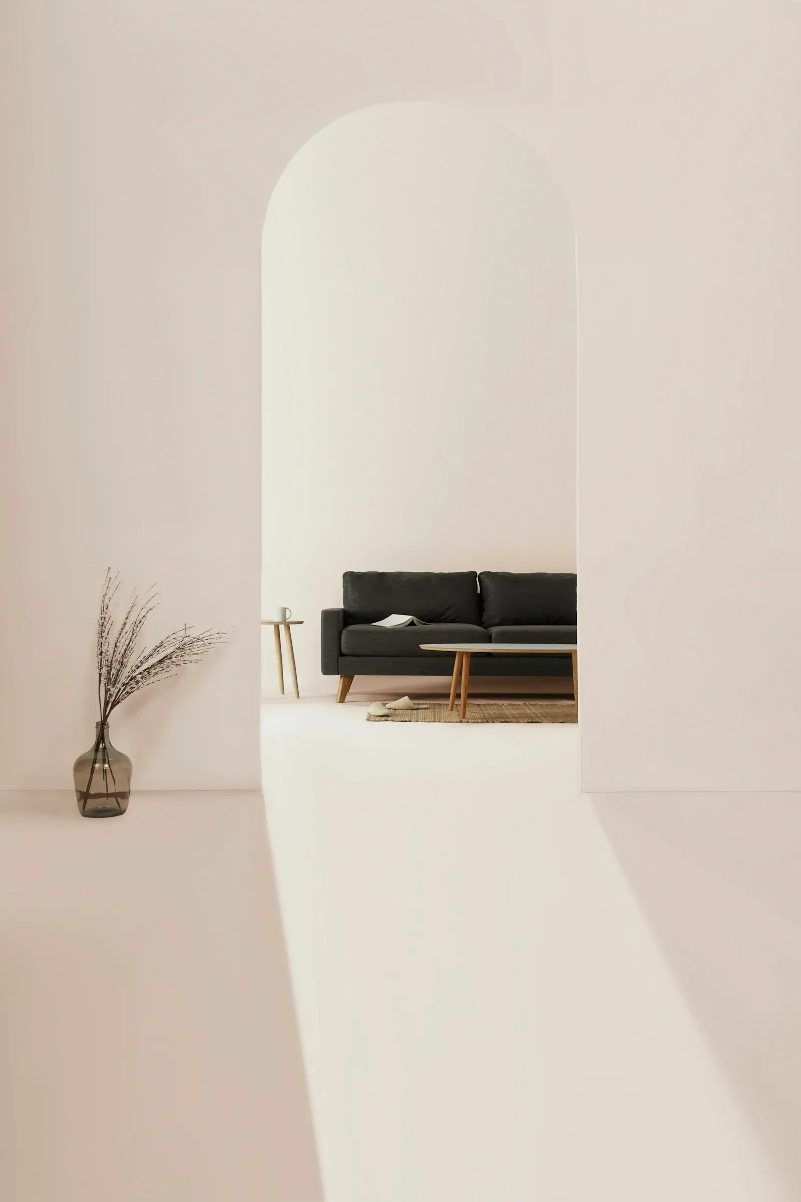 Minimal plaster alcove with a low bench and a single dried branch