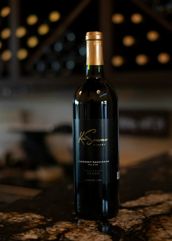 Dark wine bottle standing on a bar